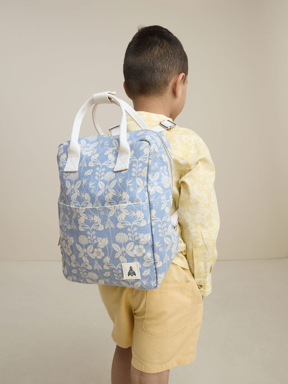Boy wearing blue backpack