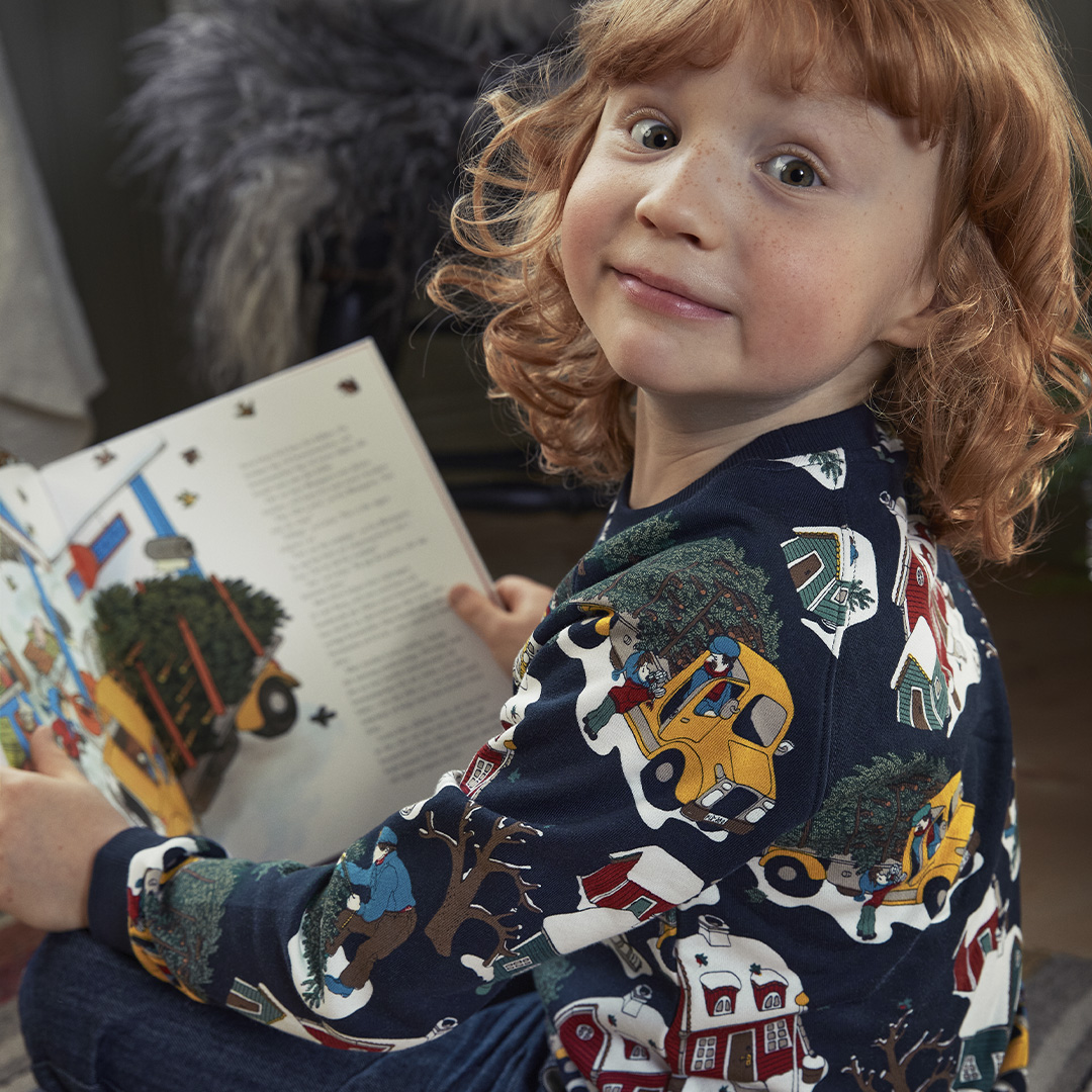 Boy reading book and wearing lotta pyjamas