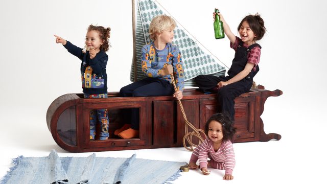 Four children wearing PO.P x Stig Lindberg clothing