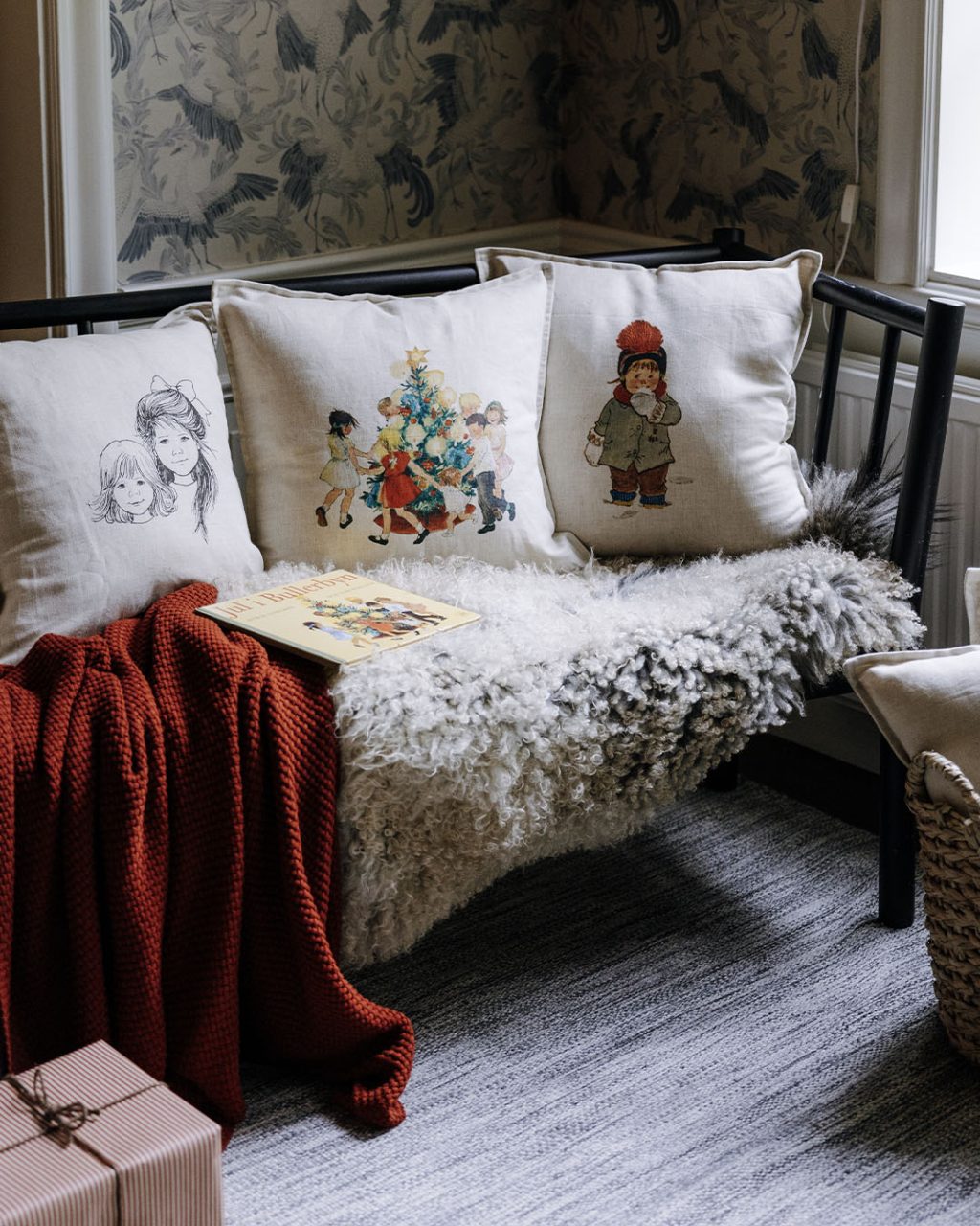 pillows on sofa with astrid lindgren and ilon wikland illustrations