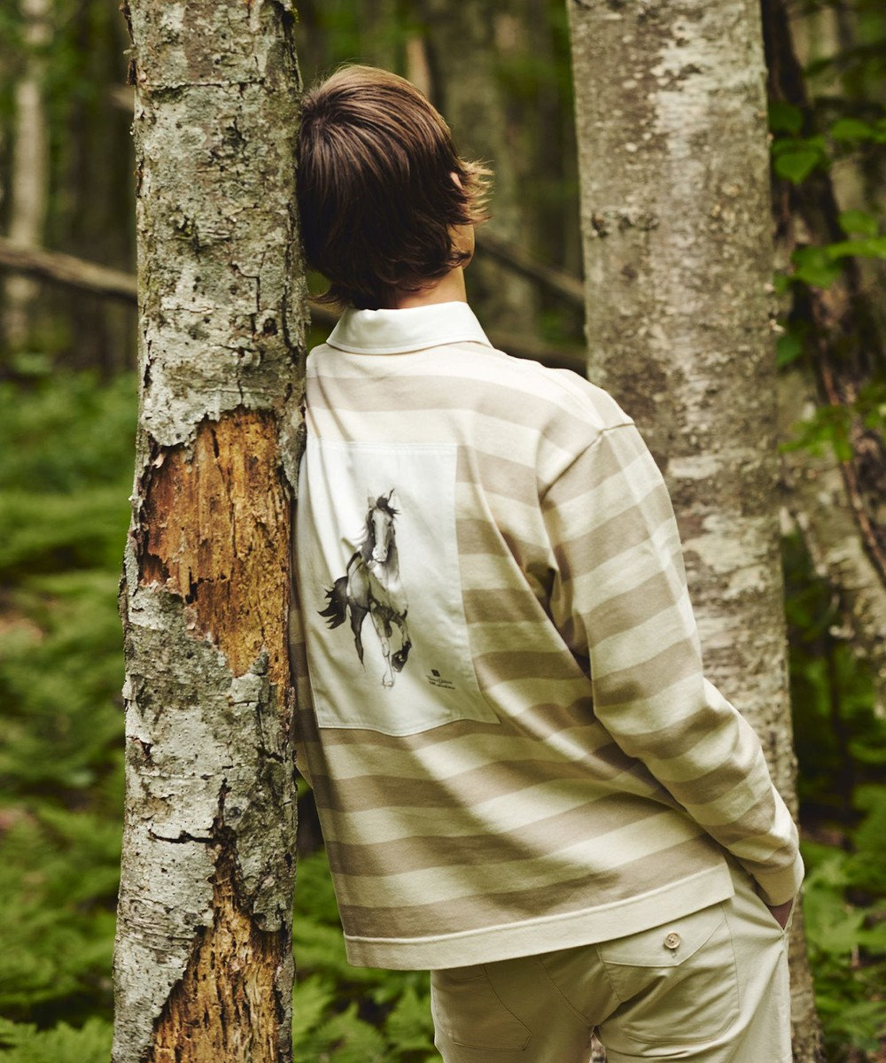 man standing next to tree